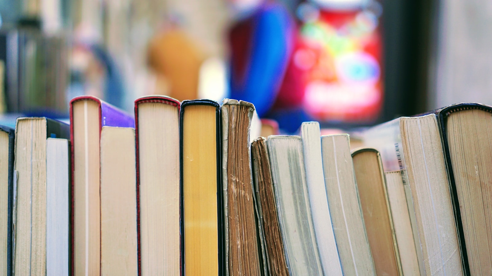 An open book lying on a wooden surface with pages spread