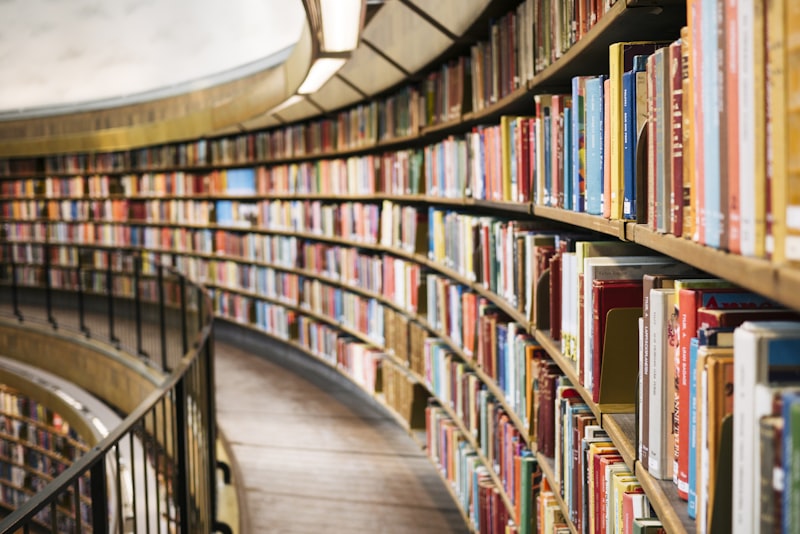Neatly arranged books on a shelf with even spacing and clean spines